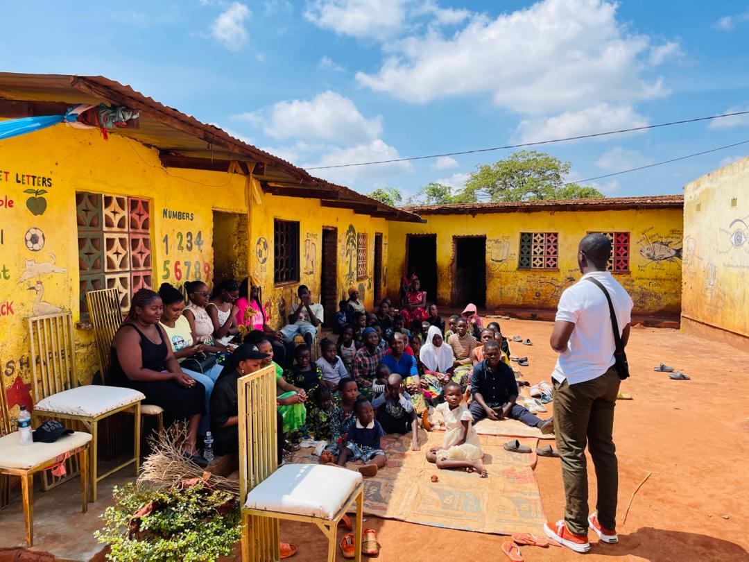 A smiling volunteer handing out supplies to a community member.