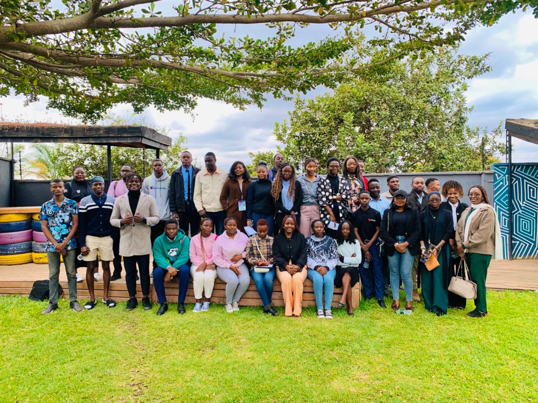 Diverse group of young people in a meeting, planning a project.